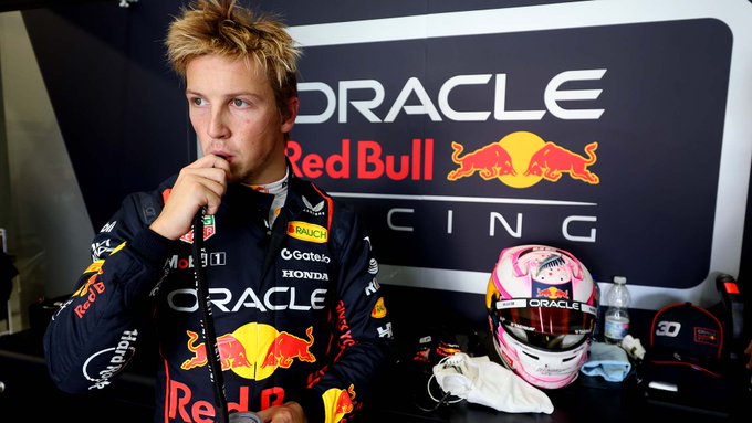 Liam Lawson sips a drink in the garage at Jerez.