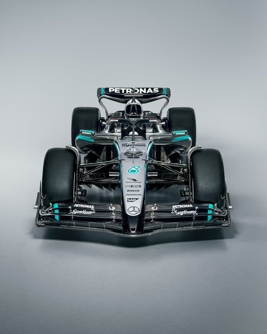 Front-angle of the W16 in a studio environment. The W16 livery features black front and rear wings, sidepods and silver nose and chassis. PETRONAS green accents feature on the front wing, sidepod, wing mirror and rear wing