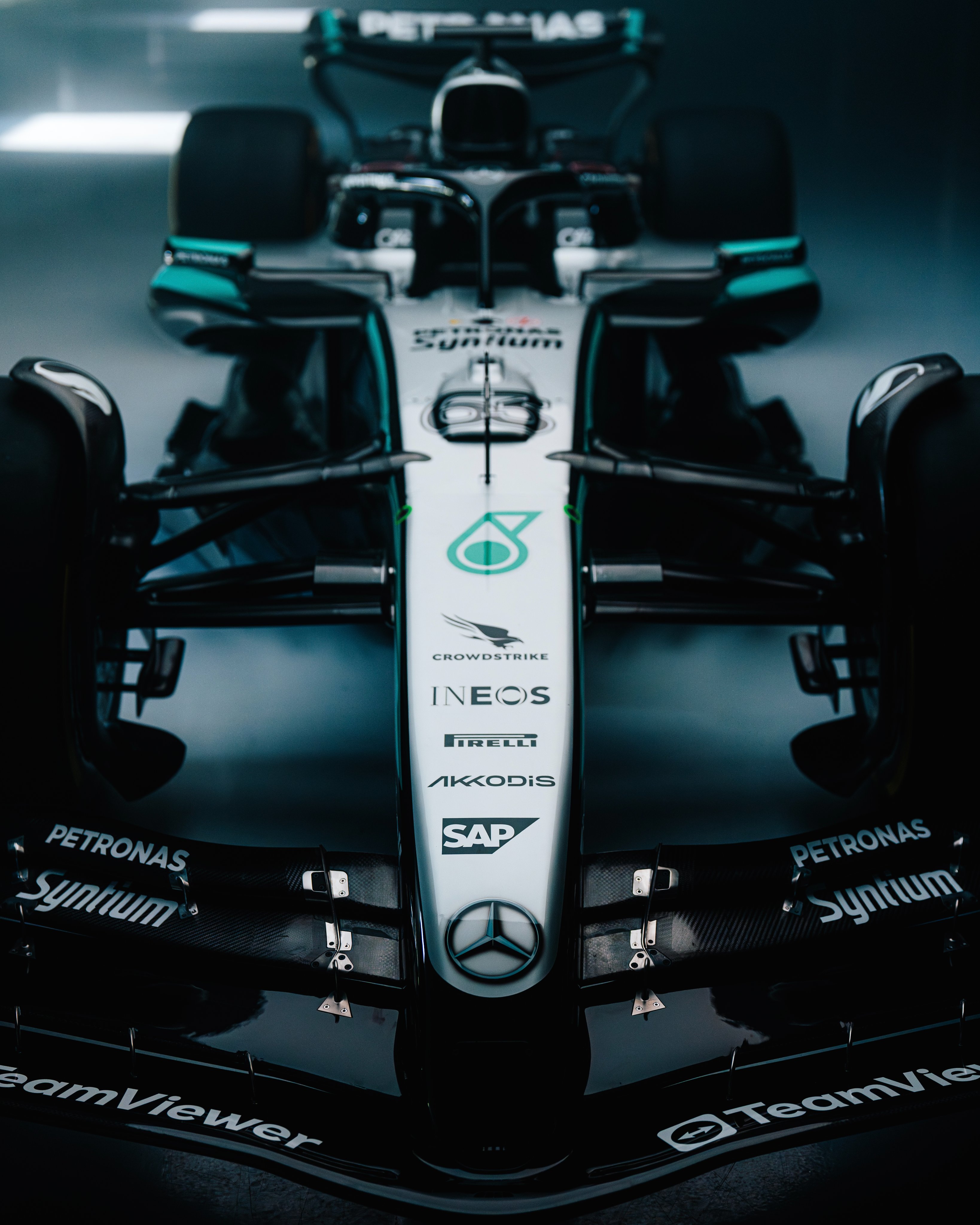 A front-angle, close up image of the W16 showing the silver nose cone, black front wing and sponsor logos on the car
