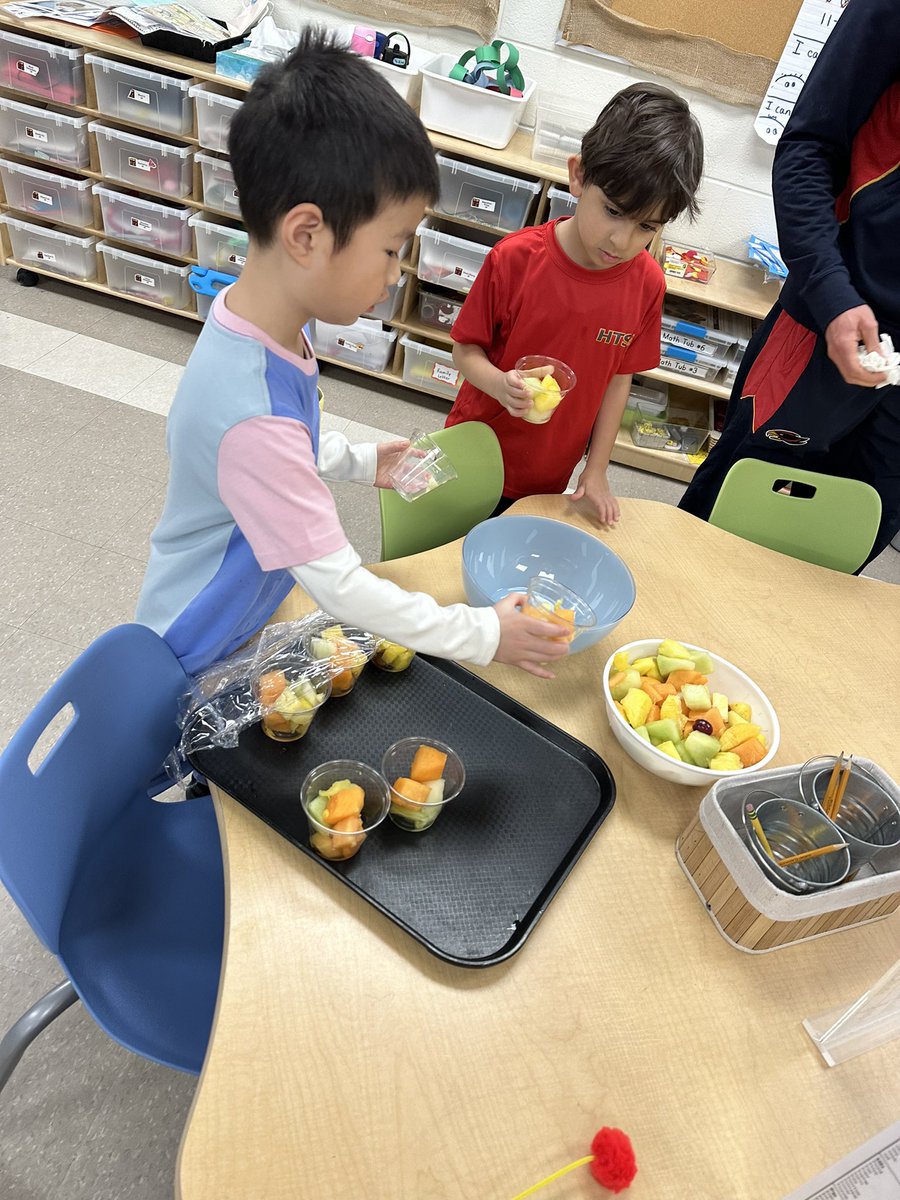 Moving the fruit snack into a bowl and saving the cups. Reducing our waste!