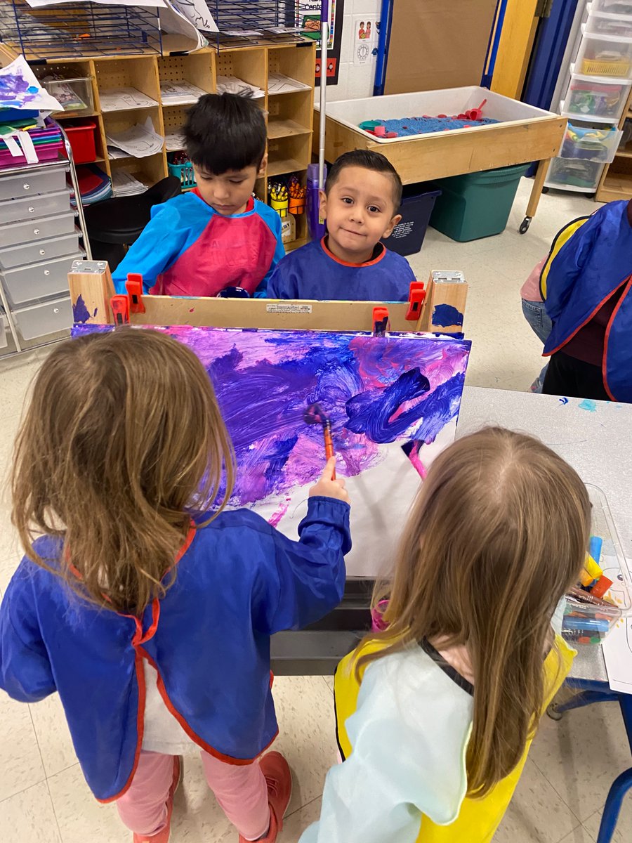 The preschoolers did friendship painting at the art center. They invited a friend to paint with them and practiced sharing space and materials, as well as, communicating their ideas of what to paint to each other!