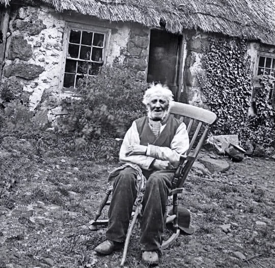 This photograph, taken around 1895, captures William McCartney (1797–1899) at his home in Ballycraigy, Carnmoney, Co. Antrim. McCartney, who lived a remarkable 102 years, stands as a figure of local significance, representing the resilience and longevity of individuals in rural