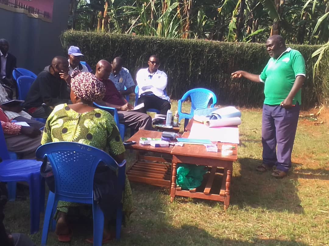 Ngomba farmer field school members at a farmer training session at Mr katos Gardens who doubles as a group treasurer and an agriculture professional. Today