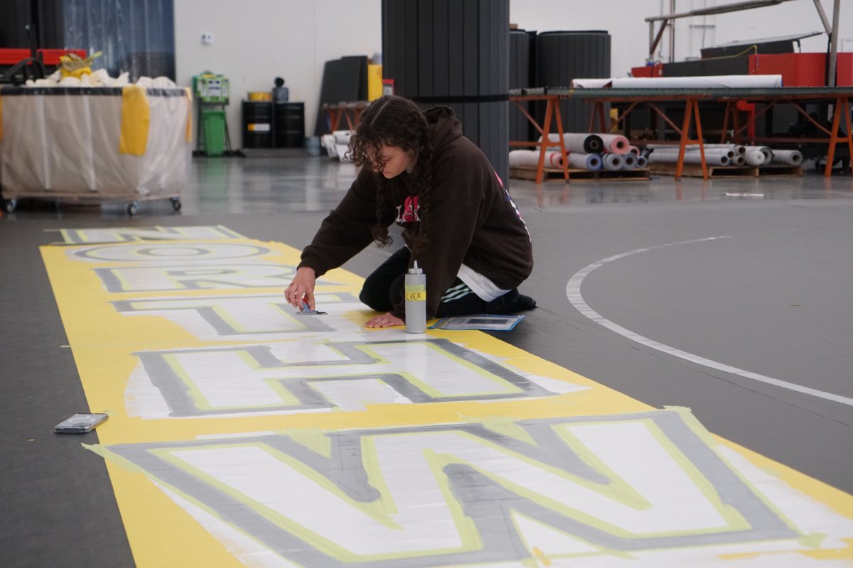 Dollamur's tweet photo. Hand painted 42’ wrestling mats getting their finishing touches done here in Fort Worth, TX before heading out. https://t.co/MxF2M9vAYb