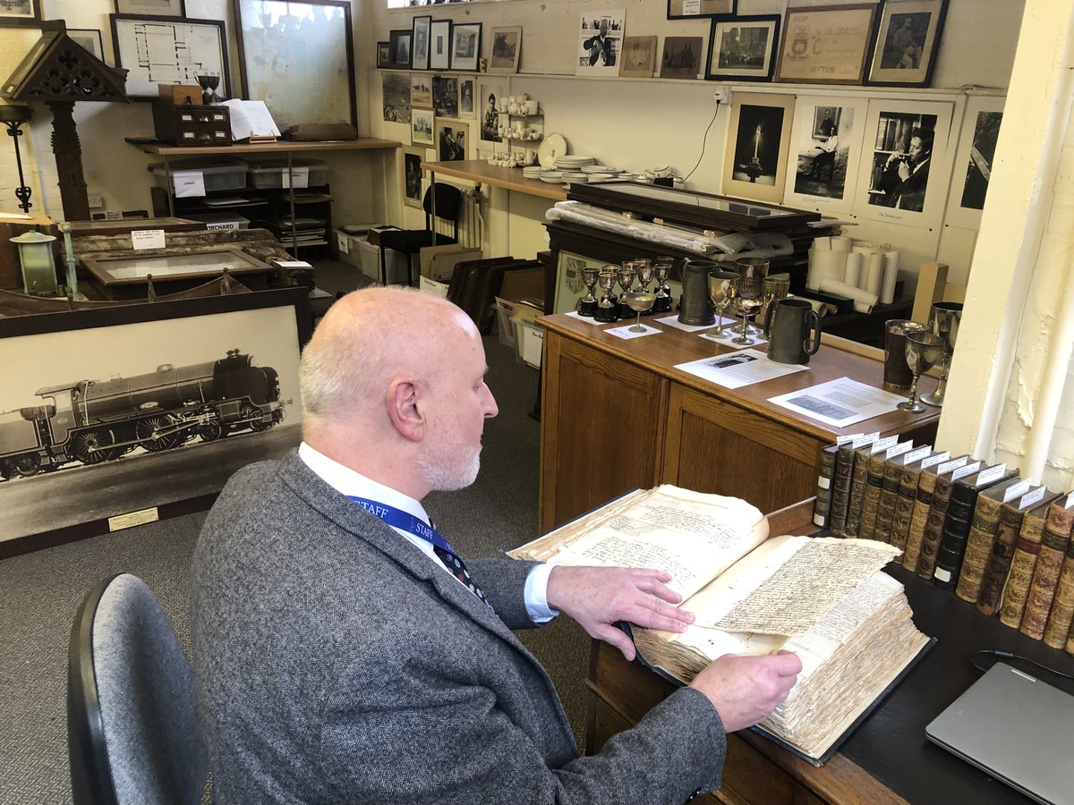 ReptonArchives's tweet image. Celebrating the first #SchoolArchivesDay with four photos of the School Archive, including documents from the medieval Priory, a 1621 charter bearing the Great Seal of James I, bound copies of the School magazine, and a photo of me perusing a volume of bound 17th century letters.