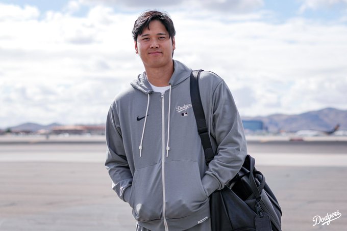 Shohei Ohtani smiles and poses for a photo.