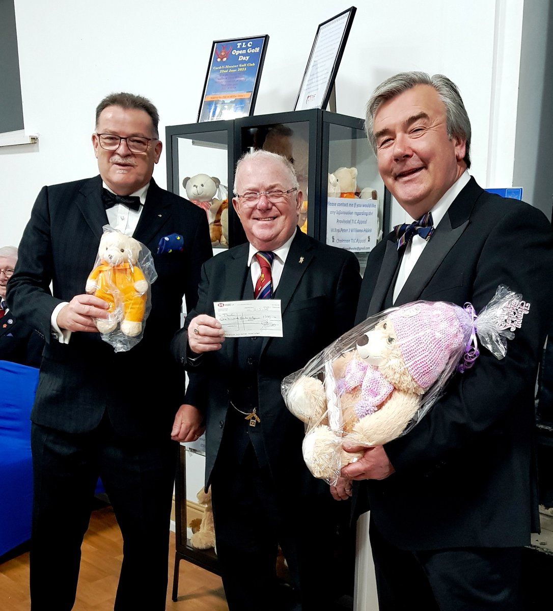 Worshipful Master John Anderson and Worshipful Brother Robert Cook, presenting a charitable donation on behalf of the Lodge of St. Illtyds to Peter Williams, Chairman of the Provincial TLC Appeal. The presentation took place at Neath Masonic Hall.