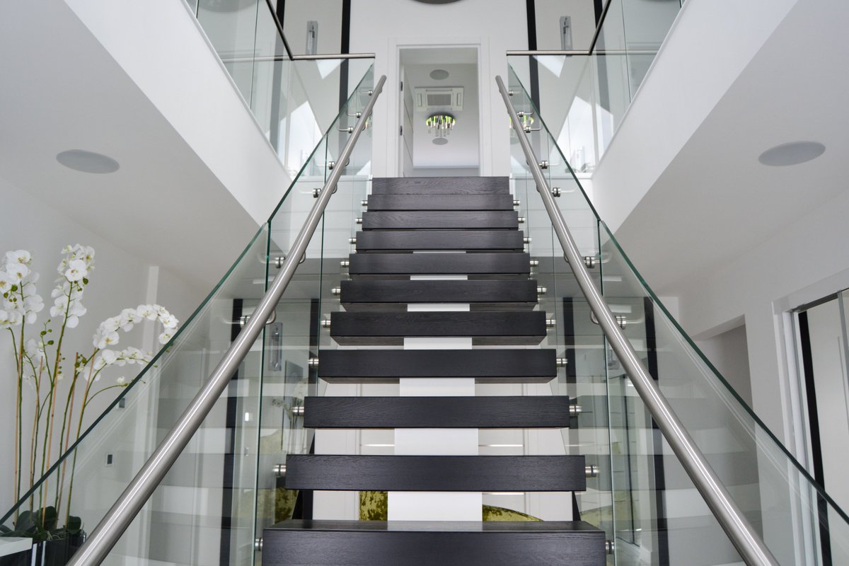 Have you thought about including a floating staircase flanked with glass in your next renovation project?

A design like this can create a modern, high-end space within your home. This helps deliver a clean, streamlined look that will capture the attention of all your guests.