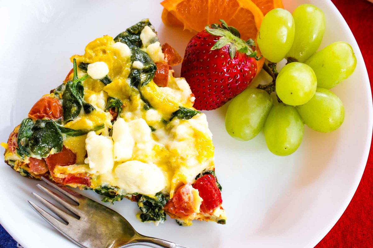 This Spinach Frittata with tomatoes and feta is light, fluffy, and easy to make with just four ingredients. Perfect for a quick dinner, meal prep, or a gluten-free brunch for any occasion. #Frittata #GlutenFree 
l8r.it/WmZ0