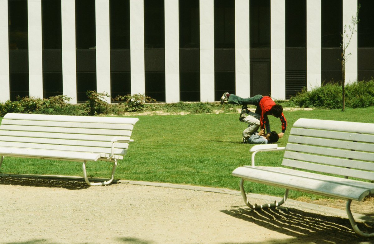 Youth defies gravity between stark urban lines 🏙️ | Green oasis where concrete dreams &amp; rebellion collide 🌱 | Parkour poetry frozen in time ⚡ #UrbanAcrobatics, #CityEscape, #StreetFreestyle, #ModernContrast, #GreenCanvas 🛹✨
