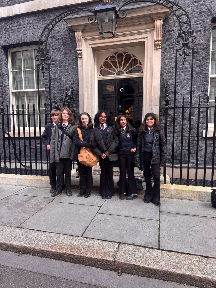 ‘Cathays High students visiting Downing Street yesterday as Welsh debating champions with Miss Maynard. They also met the Prime Minister!’