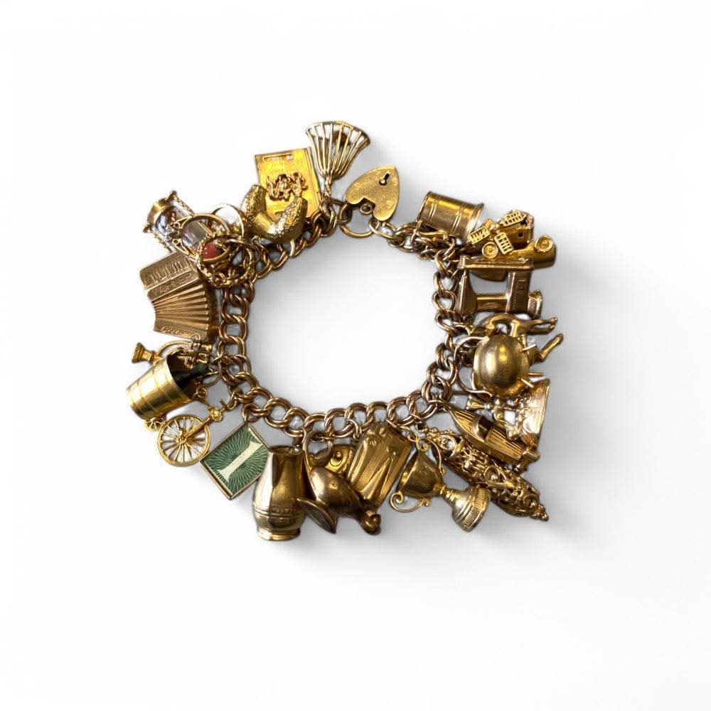 Lot 5 in our Friday sale:

9ct Yellow Gold Hallmarked Charm Bracelet With 25 Charms Including A Sewing Machine, Hour Glass, Deer, Passport Etc.,
£1000-1500

#charmbracelet #antiquegold #goldcharmbracelet #gold #vintagegold #auctioneer #auctionhouse #collectable #auction