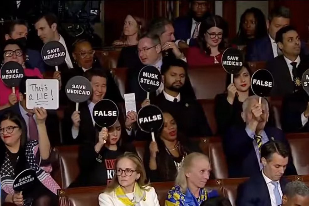 PopBase's tweet image. Democratic congress members held up signs during Donald Trump’s congress session tonight.
