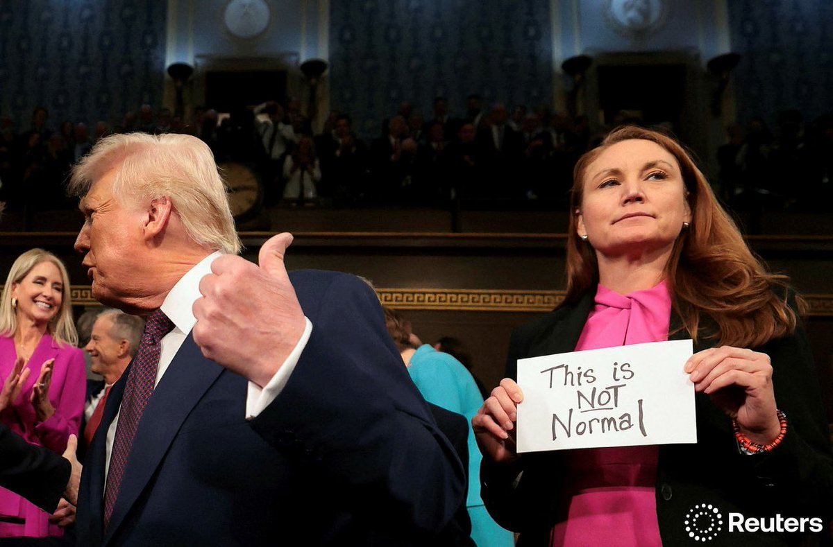 WASHINGTON, DC - MARCH 04: U.S. President Donald Trump arrives for his speech to a joint session of Congress as Rep. Melanie Stansbury (D-NM) holds a sign reading "This is not normal" at the U.S. Capitol on March 04, 2025 in Washington, DC.     Win McNamee/Pool via REUTERS