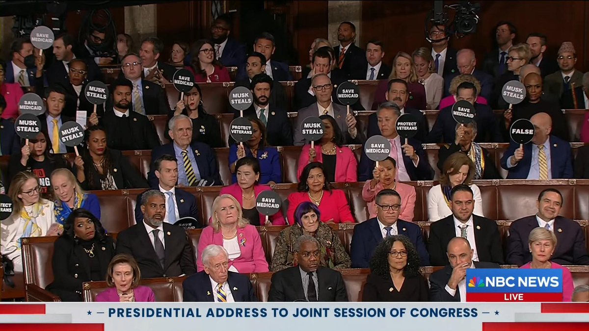 factpostnews's tweet image. Democrats hold up signs pointing out that Trump is trying to cut Medicaid while he lies on national television