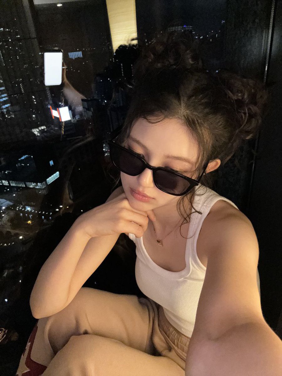 daniulle's tweet image. the sunglasses are giving “too cool to care,” but let’s be real, i definitely took like 50 selfies before deciding on this one 🫢 oh—the world below is buzzing with life; cars rushing, people moving, lights flickering. but up here, it’s just me! 🌃🛋️