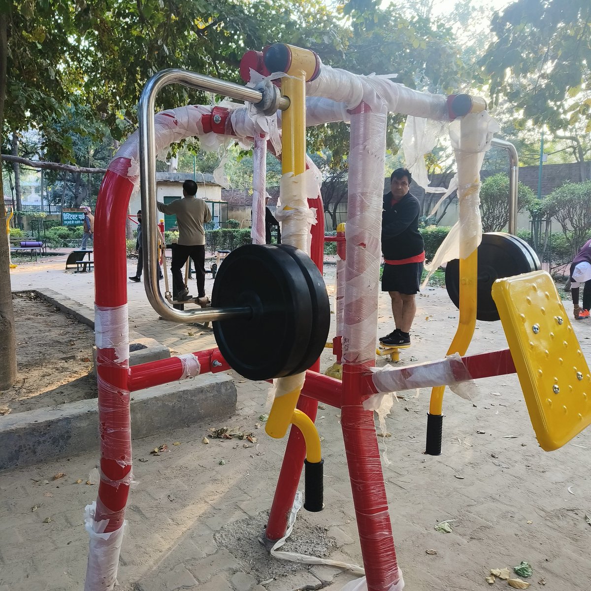 Shammijee's tweet photo. @official_dda some new exercise machines have been installed in the DDA District Park  Tagore garden near Cambridge foundation School.  thank you very much for that. but don't you think it is someone's responsibility to remove the plastic wrapper from the machines. Now it is https://t.co/3WqjRD5Evo