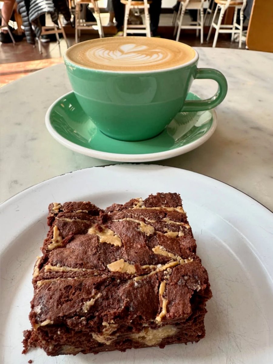 Indulging in the perfect combo: a creamy latte and a gooey peanut butter brownie!  #CoffeeLovers #SweetTreats #FoodieHeaven