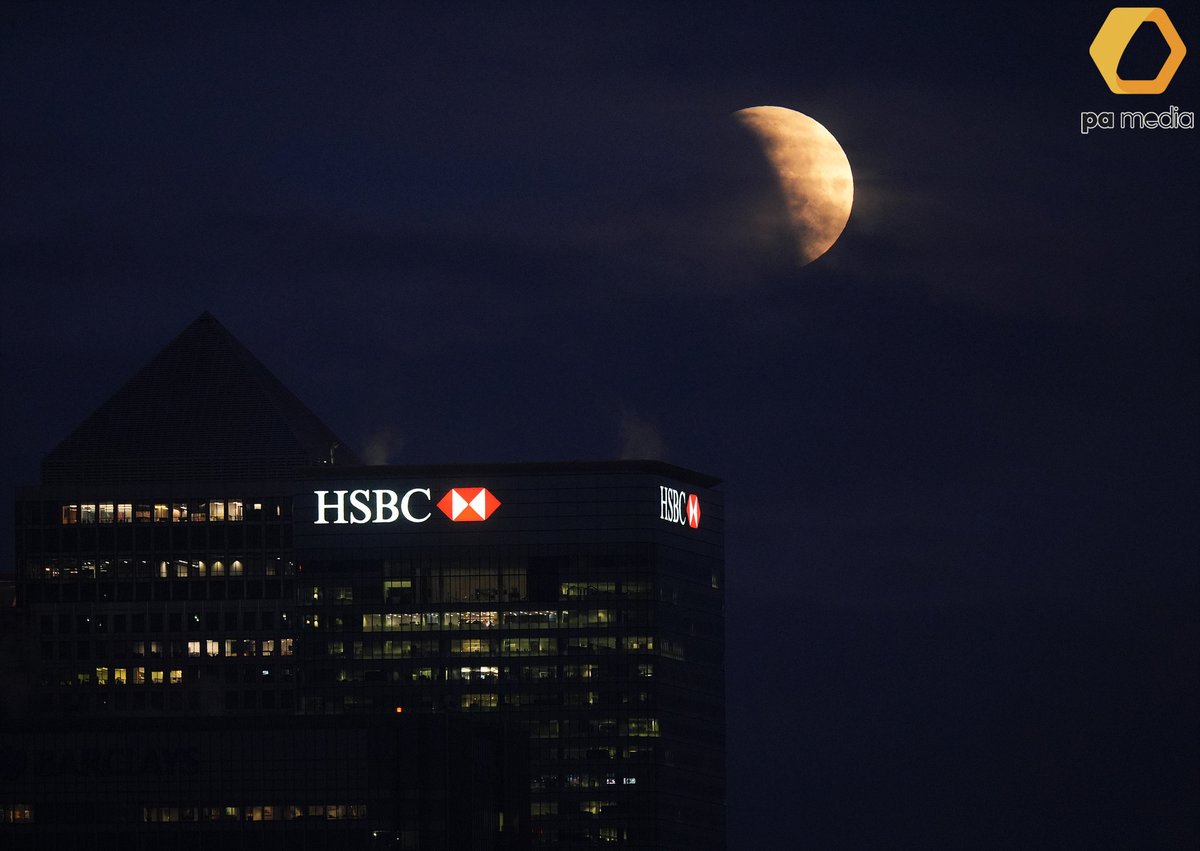 A "blood moon" partial lunar eclipse is visible above Canary Wharf in London, as the full moon passes into Earth's shadow. #astronomy #weather