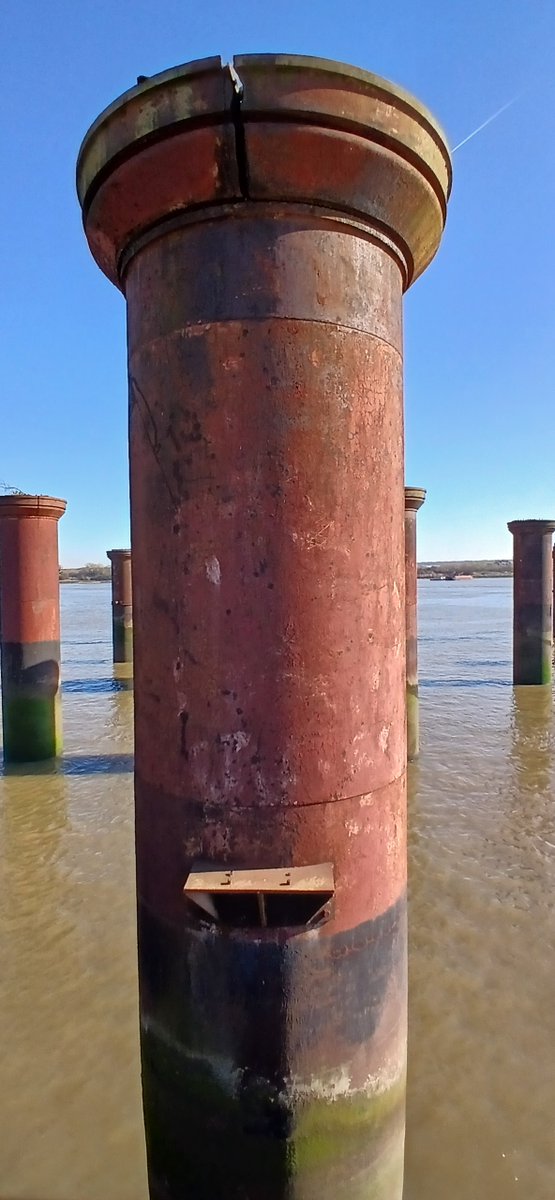 So much crammed into this part of the Thames. 
Photo taken from the former Beckton Gas Works, with the Victorian pillars of the coal ship piers in the foreground. 
To the left Beckton Sewage Works. 
Towering above it all Barking Creek Barrier on the tidal Roding.
1/2