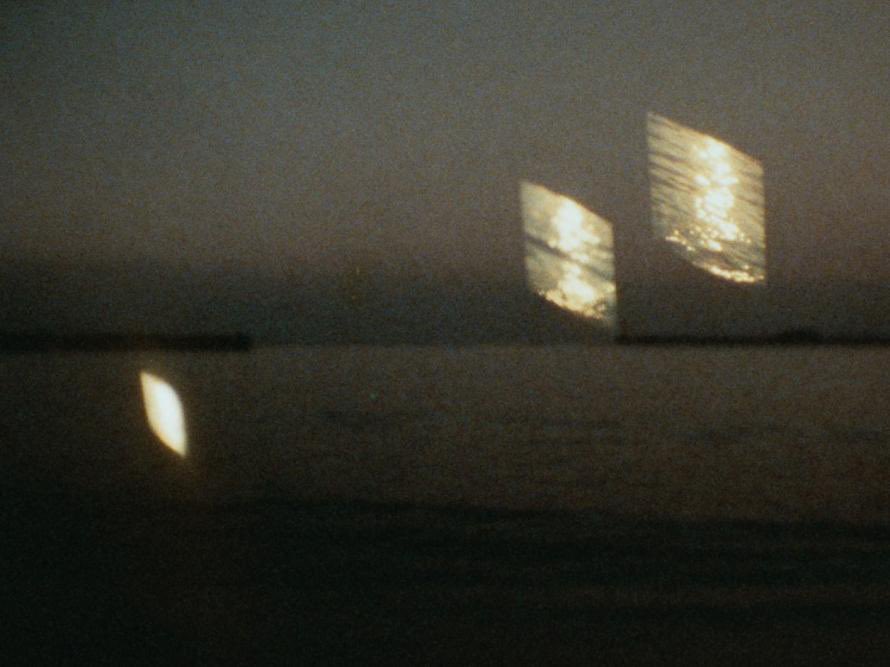 居田伊佐雄『満潮』(81) 『Far from…』は流水音だったがこちらは波の打ち寄せる音。ある時間＝画面のなかに別の時間を投射する。中盤、歩かれる地面と撮影者の影に小窓状の波が被さって物語映画における溶画についても考えさせられ。世界のなかに映像がビーム状（「光の筒の断面」）に発射されたり。