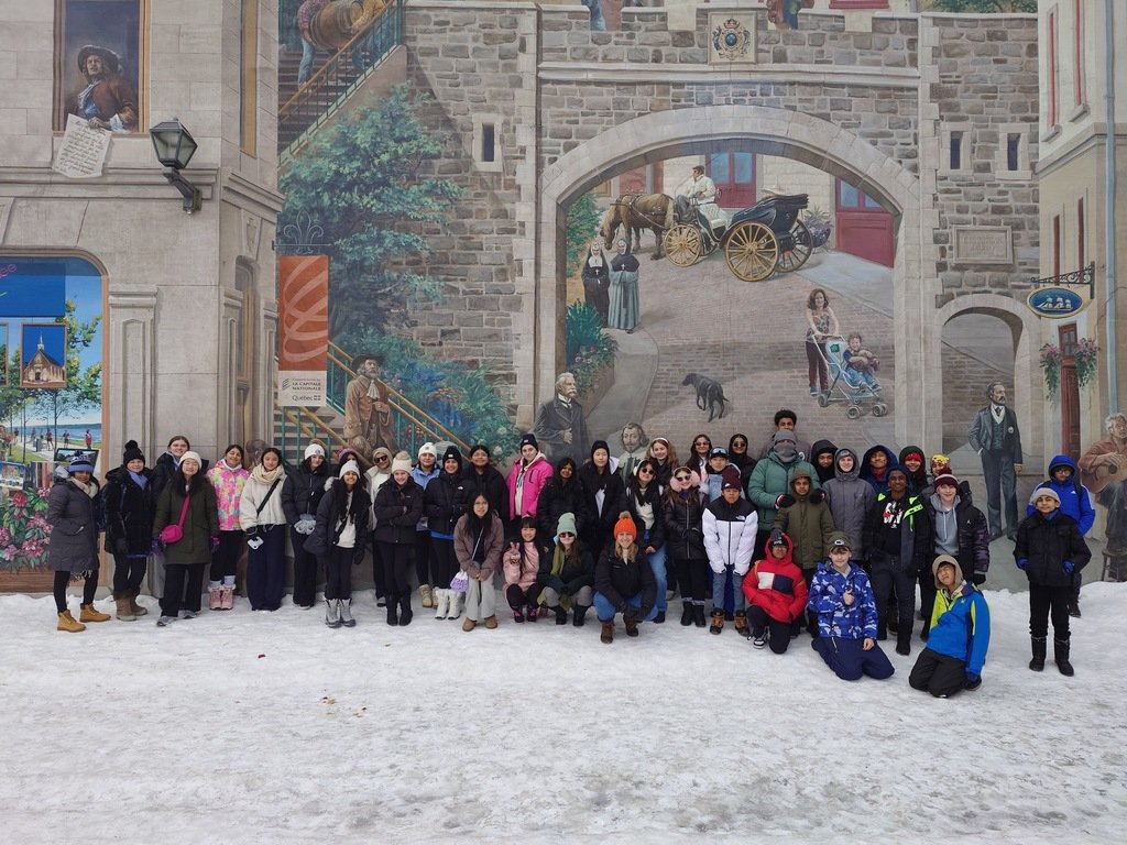 Students in John F. Kennedy Middle School's Grade 7-8 French Class are visiting Quebec this weekend! Here they are in front of the infamous La Fresque des Quebecois mural.