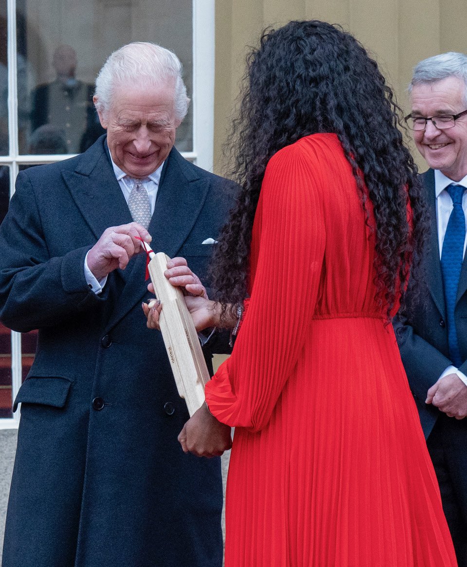 The King places a note in the Commonwealth games baton which he passed to Sir Chris Hoy to start the relay