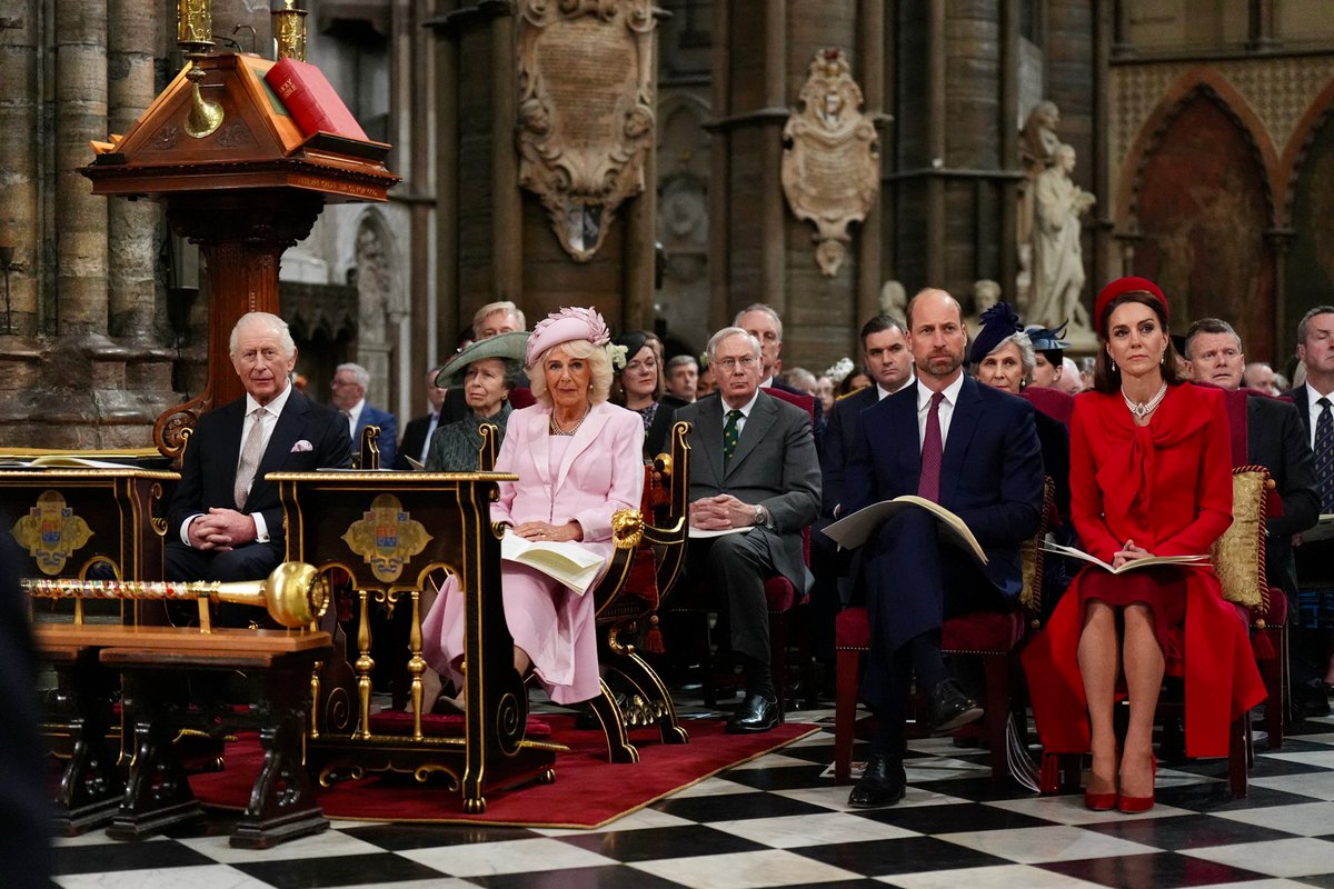 The King and Queen are seated behind desks bearing the Royal Coat of Arms of Canada at the Commonwealth Day Service, 2025.