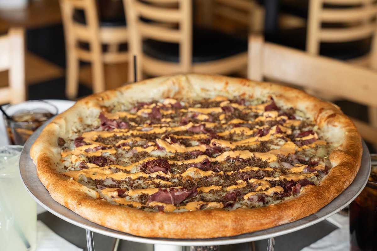 Introducing... Uptown Reuben ✨ an elevated take on the classic Reuben! Featuring, olive oil, sauerkraut, mozzarella, corned beef, Swiss cheese, caraway seeds, rye breadcrumbs and housemade Thousand Island dressing after the bake. Try it today at deweyspizza.com