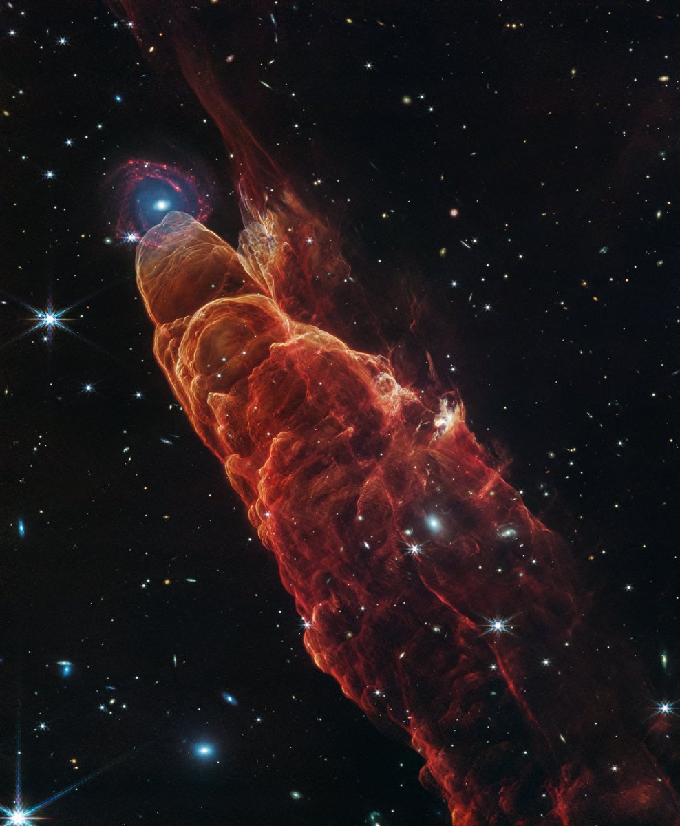 NASA’s Webb Telescope just captured something wild...  a newborn star creating what looks like a cosmic tornado.
This isn’t actually a storm in space, though. It’s called a Herbig-Haro object (HH 49/50), and it's formed when jets from a baby star slam into surrounding gas and