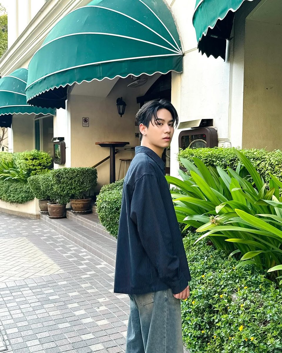 satang's tweet photo. Standing beneath the midday sun, draped in a stripe navy long shirt, I find myself in a quiet competition with the golden light—yet somehow, we complement rather than compete. https://t.co/zCqaLjUBb6