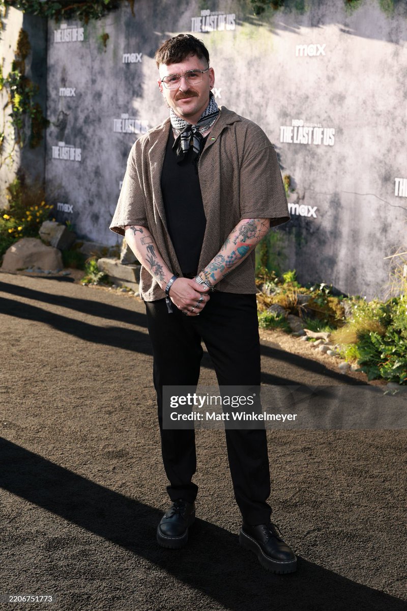 Julien Solomita wearing a Palestinian flag and a keffiyeh iktrrr