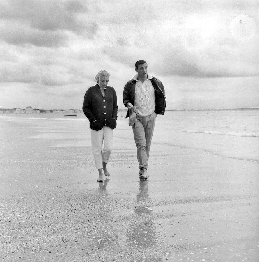 Simone Signoret and husband Yves Montand photographed walking along the beach at La Baule, in Southern Brittany, 🇫🇷France (30 July 1959)