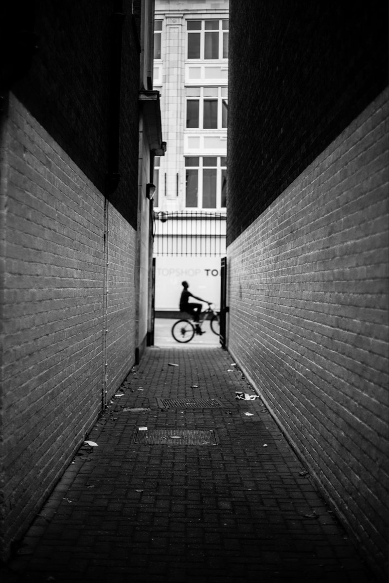 Proud of this shot I took—capturing a random cyclist in this narrow alley felt like stepping into a noir film. The shadows and contrast just hit right.