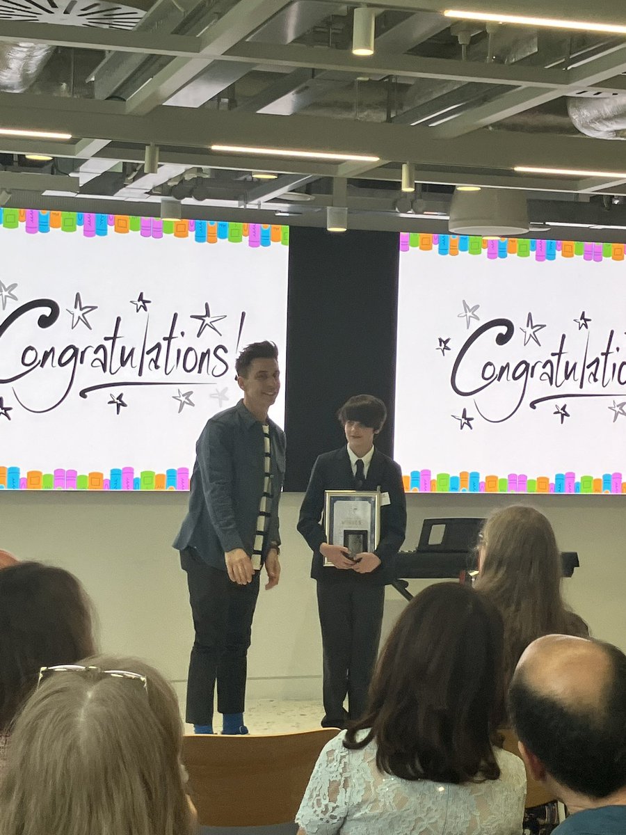 Amazing speech today from author &amp; comedian <a href="/russell_kane/">Russell Kane</a> about the huge value of returning to books &amp; libraries throughout our lives, &amp; the transformative power of reading. Great cat stories too 😉 Thank you for celebrating our student Micah &amp; making him feel special!
