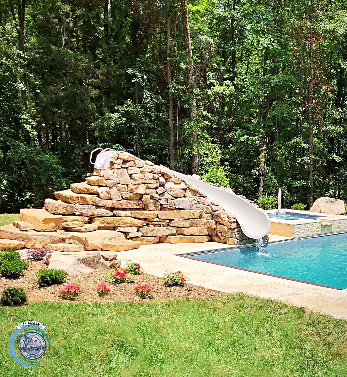 PoolscapesCLT's tweet image. That’s one cool slide.  Custom rock facade for the pool slide.  These are our Great Lakes pool and Lido spa fiberglass model. #poolandspa  #poolslide #poolfeatures