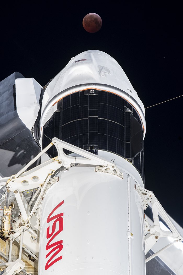 LaunchPhoto's tweet photo. Lunar eclipse over Crew Dragon and Falcon 9 https://t.co/hfrxiTcM8g