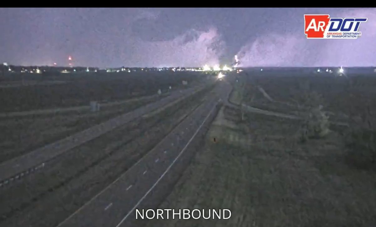 Praedictix's tweet photo. Wow! Check out this Tornado with lightning bolt⚡️captured on #ARDOT camera last night! Massive damage already being reported across several states, including St. Louis, MO. May not be much time to assess damage before round 2 unfolds today with numerous deadly tornadoes. https://t.co/Mu8HIt1f0N