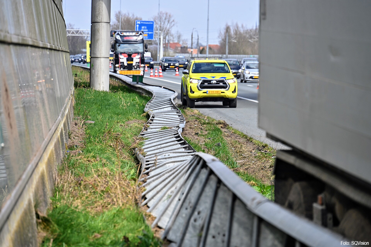 Vrachtwagen in de vangrail na klapband op A16