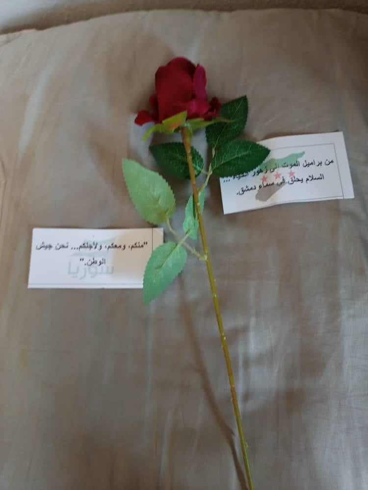 alMarraToday's tweet photo. For the first time, the Syrian army throws roses and paper scraps at Syrians in Damascus on the anniversary of the Damascus uprising against the Assad regime. https://t.co/9ccNY1L74y