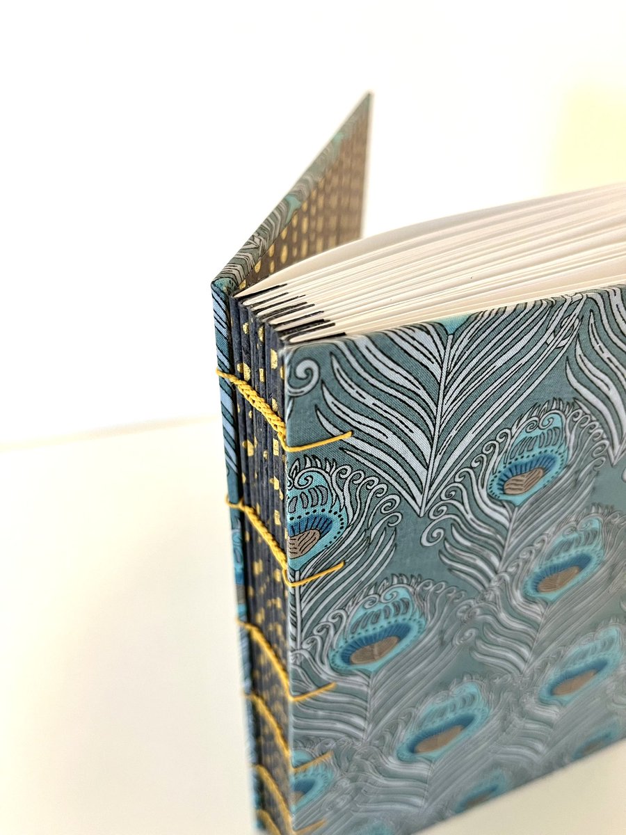 BoundByYuko's tweet photo. I was working on these custom-order books for a couple of months! Decided to go with the fabrics I picked up at Liberty London a decade ago. It was challenging to use materials with patterns for the outside and inside the book, but I think I pulled it off. 
#bookbinding #sendai https://t.co/XaXpqQQErG