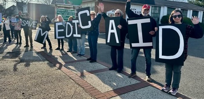 GloriaBB2's tweet image. Yesterday we joined a small but enthusiastic group of about 20 others in exercising our right to peacefully demonstrate against this awful administration. Mostly positive reactions from drivers passing by!  #Resist #StandUpForDemocracy 

*I held the &quot;M&quot;, my wife the first &quot;I&quot;