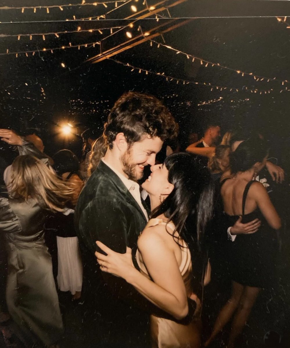Claudia Doumit and Jack Quaid sharing an intimate moment at a nighttime event