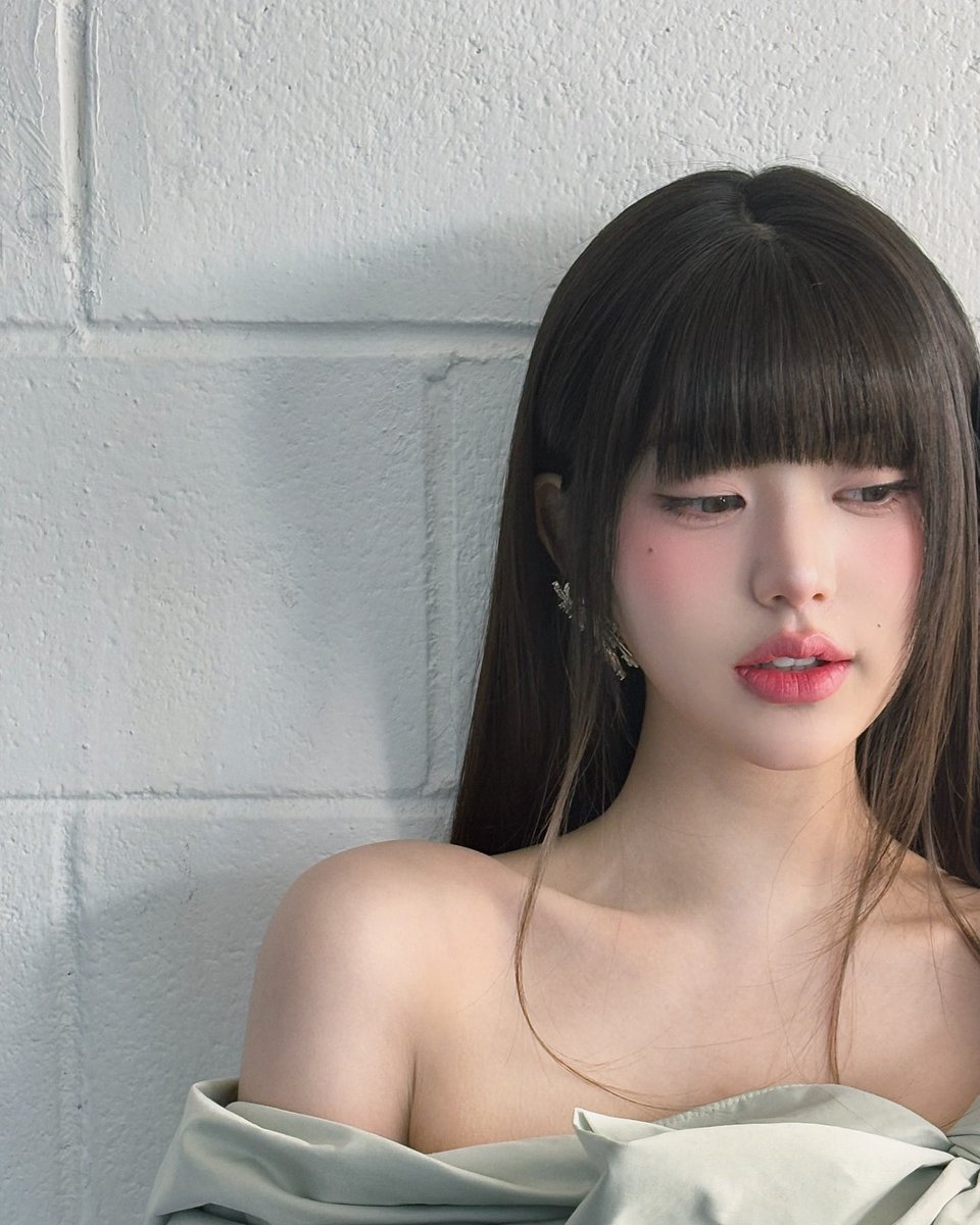 My wittle heart skips as I lean against this dreamy white brick wall, my silky off-shoulder dress draping so prettily. My glossy hair flows, bangs tickling my forehead. I peek with sparkly eyes, rosy cheeks blooming, dainty earrings twinkling like a cute dolly. ♥︎