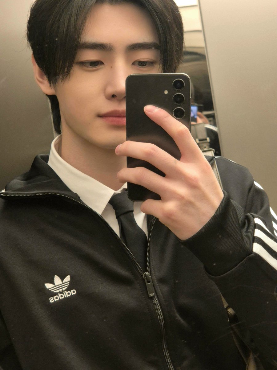 sunghoon blessing the elevator mirror inside the building