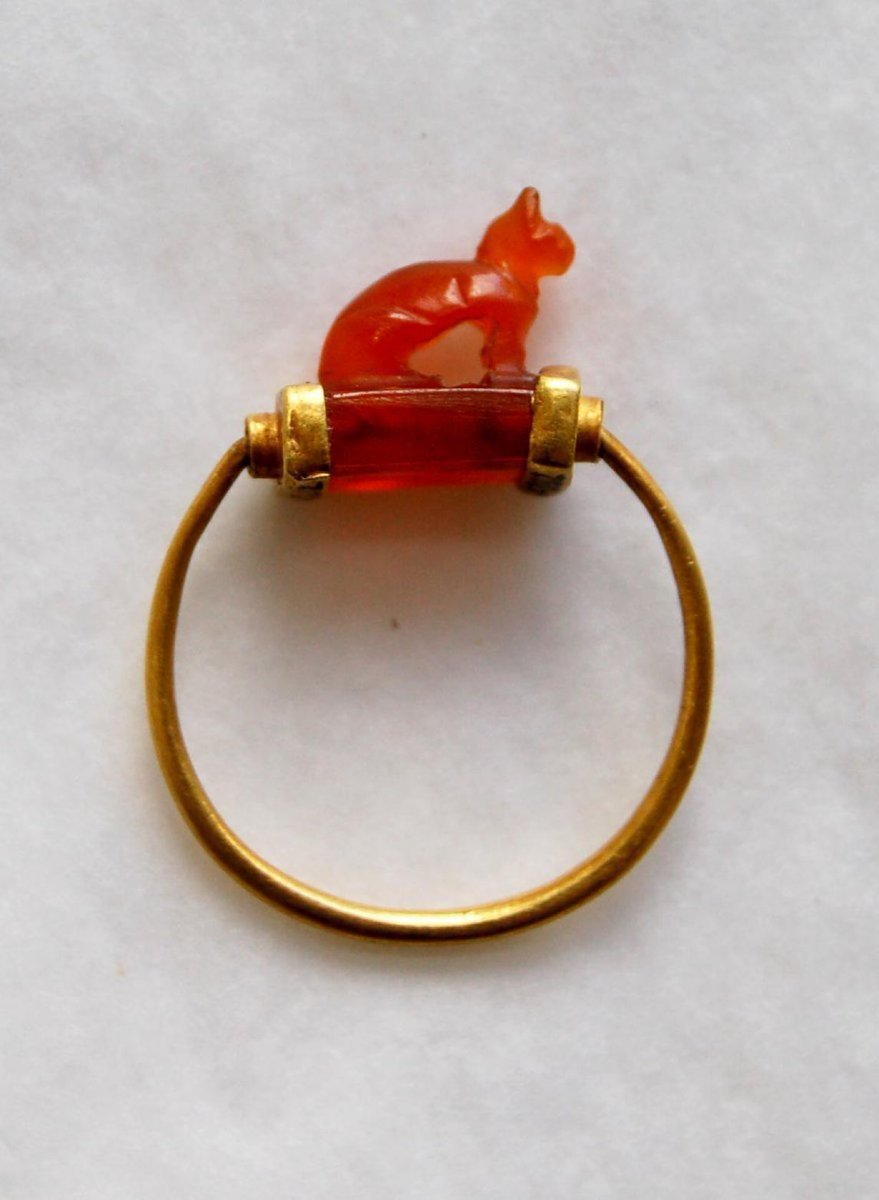 12. An ancient Egyptian gold ring made between 1070-712 BC,  featuring a cat carved from carnelian.