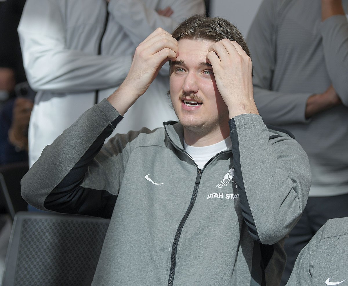 Utah State basketball players react as they watch the NCAA Selection Show on Sunday in Logan. The Aggies received a 10 seed and will play UCLA.