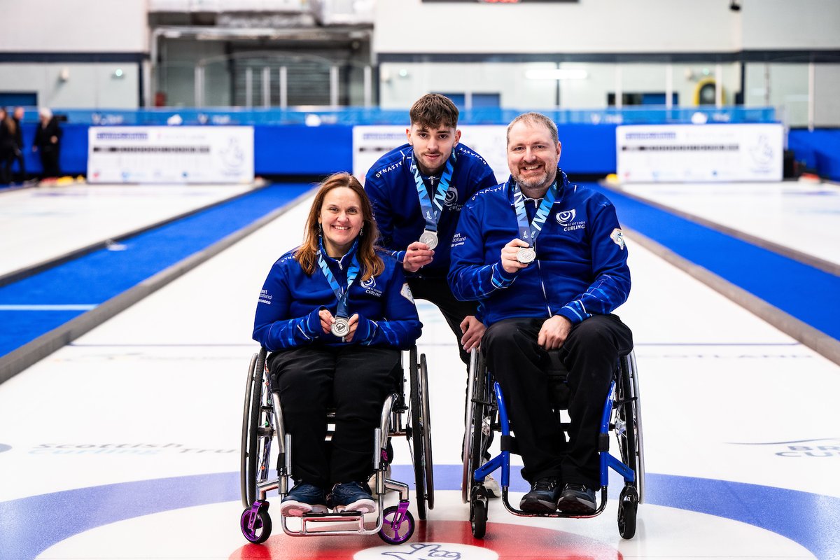 BritishCurling's tweet photo. 🥈🏴󠁧󠁢󠁳󠁣󠁴󠁿Sterling performance from Scotland - your new @worldcurling wheelchair Mixed Doubles Champs Charlotte McKenna and Hugh Nibloe - with coach Niall Ryder. 
📸World Curling
#RoadTo2026 #WheelchairCurling #WWhMDCC https://t.co/YPbILyIZ0u