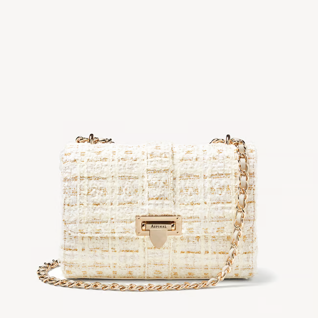 Handcrafted from full-grain leather, and a woven wool blend bouclé with ivory and shimmering gold threads for a rich finish that brings a luxurious edge to any outfit ensemble.