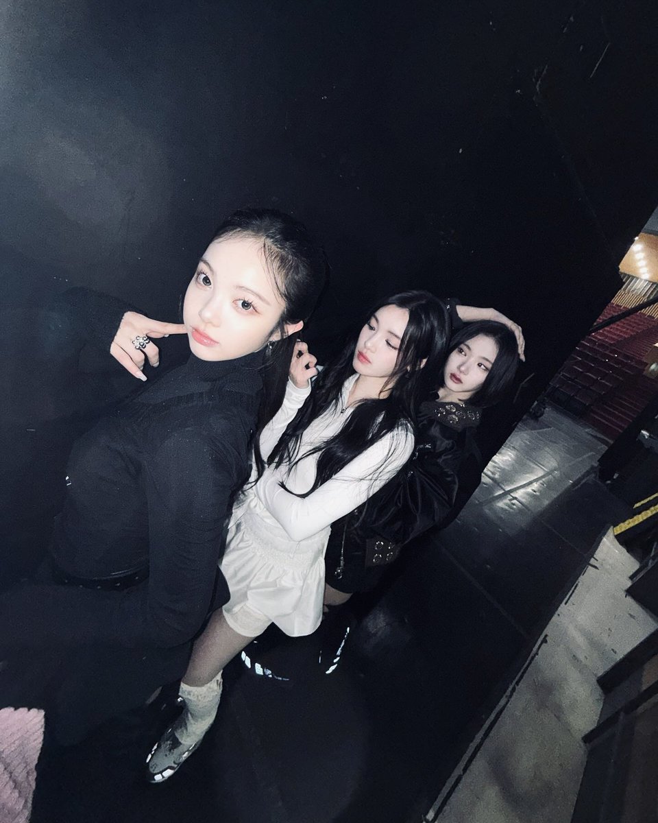eongjian's tweet photo. Standing in the dim glow backstage, with Yuha unnie and Jiwoo unnie beside me, we create our own little world. Shadows dance around us, but our energy shines through. Just three souls sharing the same stage, the same dream, and endless memories.    (...)⠀ 𓍯  .  ݁    ✦ https://t.co/wcSy5mz0Qt